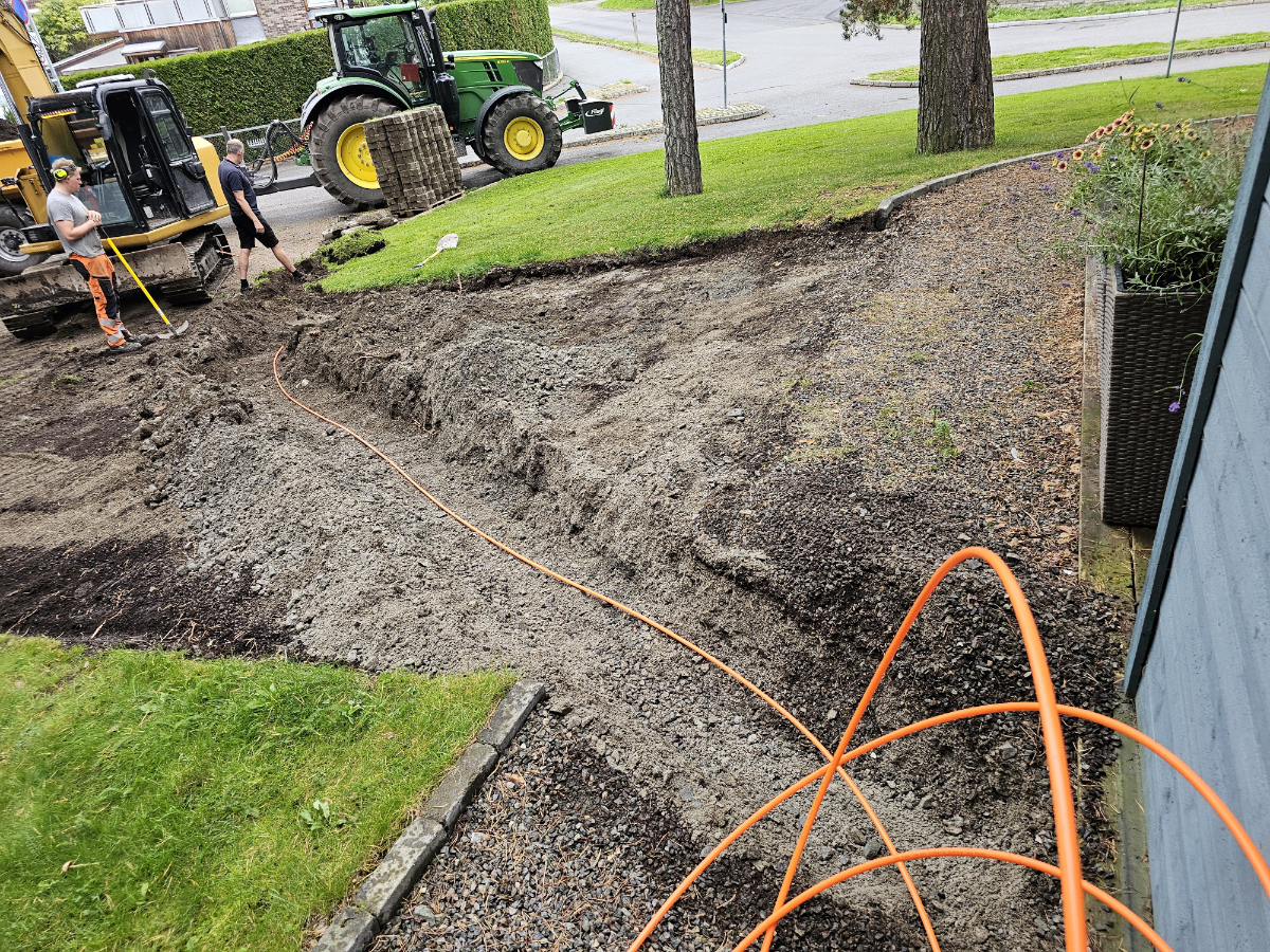 A fiber optic cable duct is being laid within the road right-of-way.